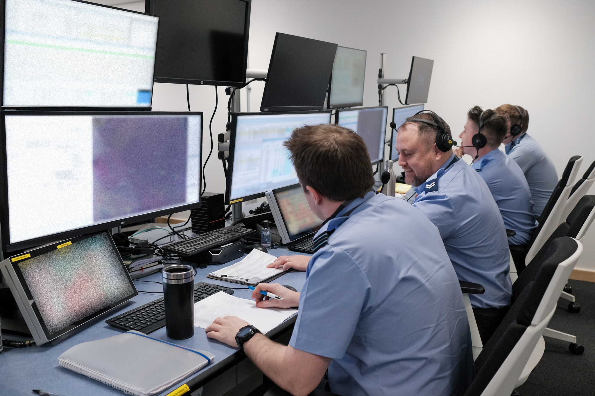 Image shows RAF aviators using computers in office.